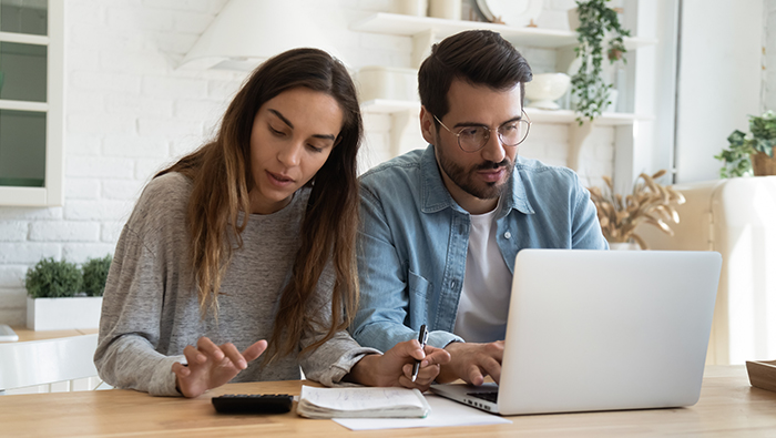 Couple with papers and laptop