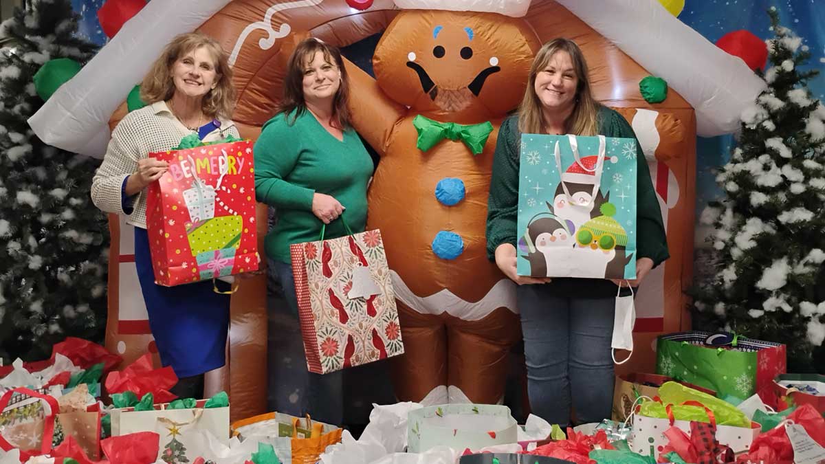 TCT's Debbie Reynolds and Jeannie Dickinson donate gifts for seniors.